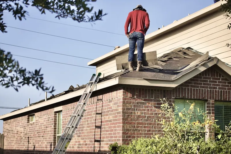 Professional roofer working on a residential roof in Hudsonville